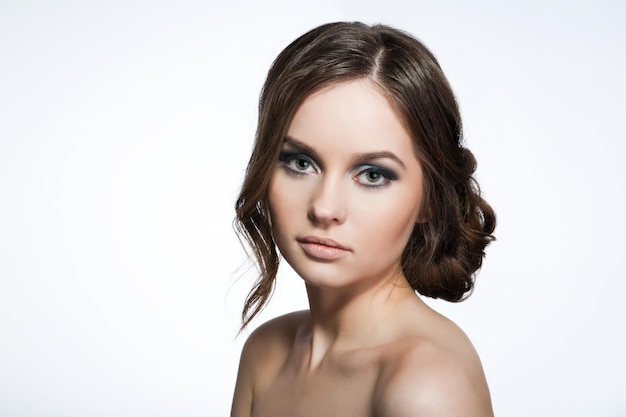 Beautiful young girl with hair collected, isolated white background