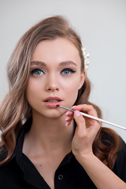 Beautiful young girl with makeup in a black shirt