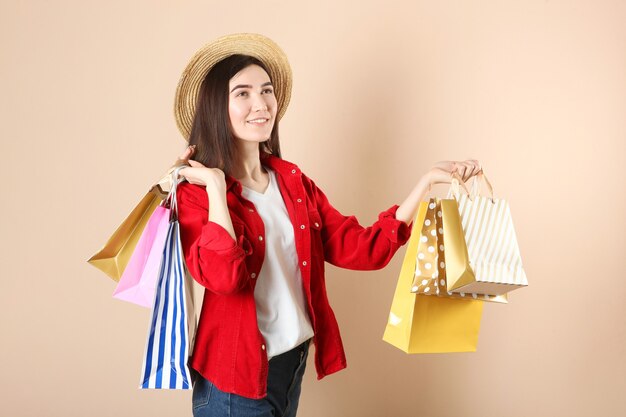 Beautiful young girl with paper bags for shopping