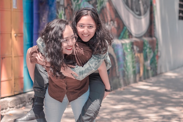 Beautiful and young girls having fun and walking around the city happy and smiling on a sunny day