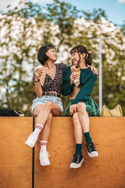 Beautiful young girls spending weekend together and looking happy