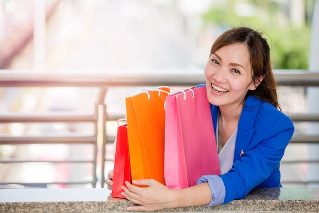 Beautiful young girls with colorful shopping bags over the path way to the shopping mall