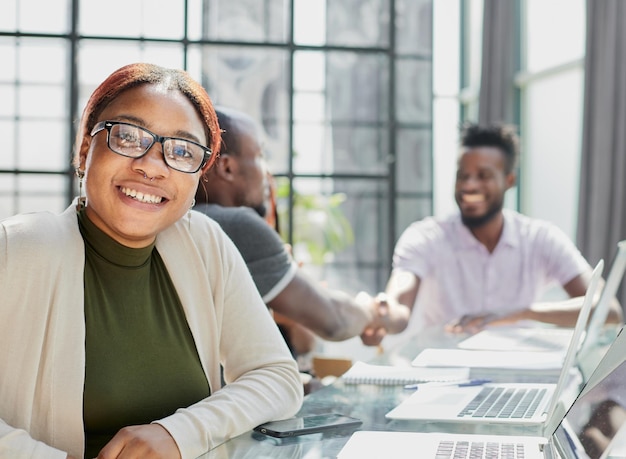 Beautiful young grinning professional Black woman in office