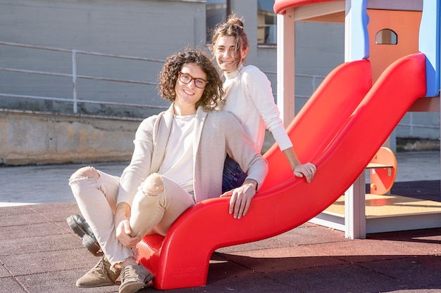 Beautiful young happy heterosexual couple at the playground