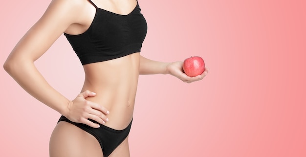 Beautiful young healthy woman with a red Apple. Diet and healthy eating