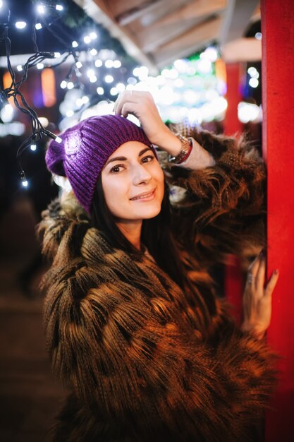 The beautiful young lady standing near Christmas fair