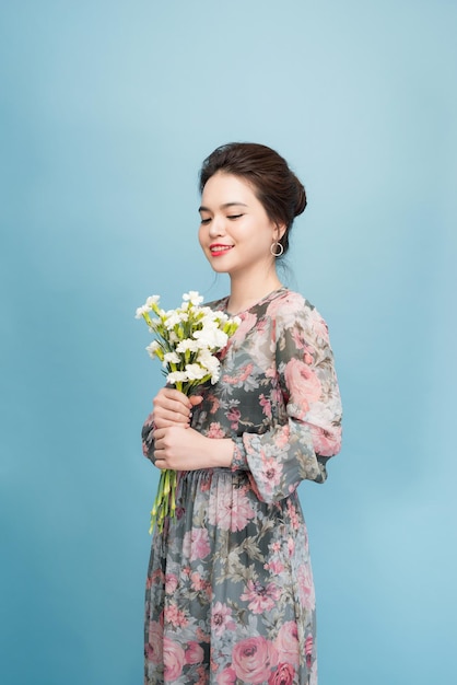 Beautiful young lady with cute dress in blue background