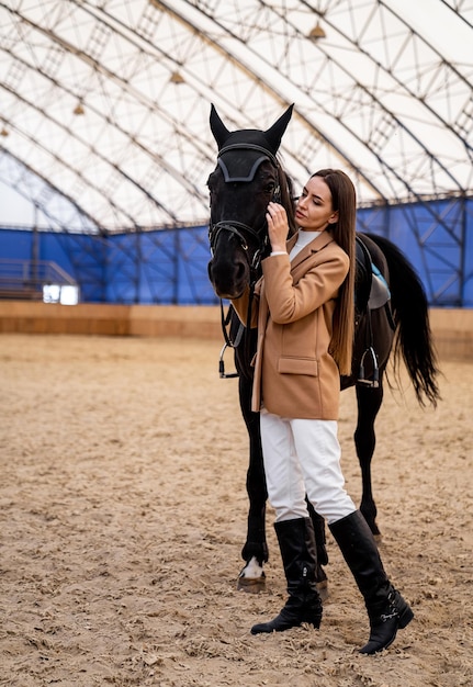 Beautiful young lady with horse Pretty woman posing with horse in field