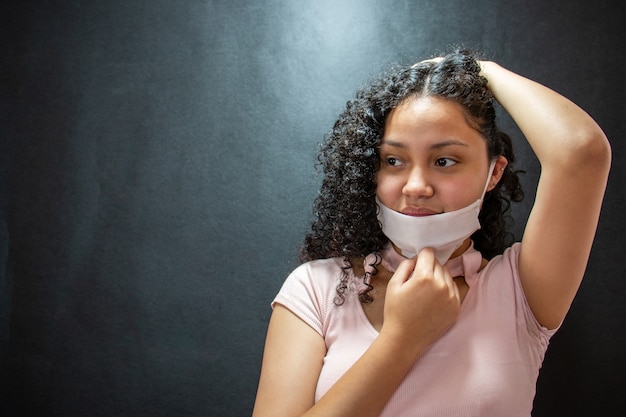 Beautiful young latin woman with medical mask