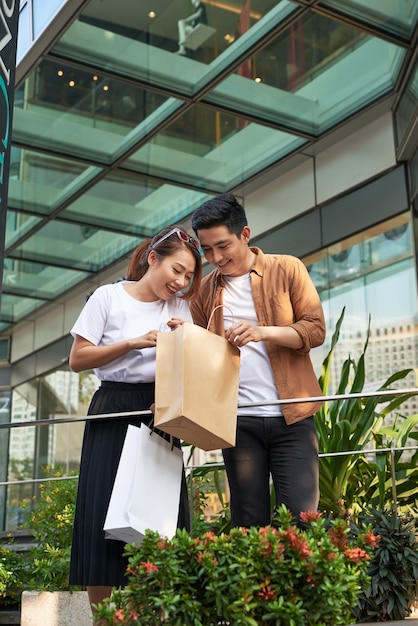 Beautiful young loving couple carrying shopping bags and enjoying together.