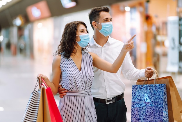 Beautiful young loving couple shopping together Black friday concept