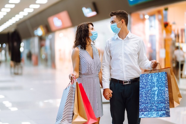 Beautiful young loving couple shopping together. Black friday concept.