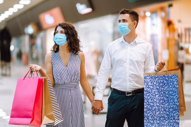 Beautiful young loving couple shopping together Black friday concept