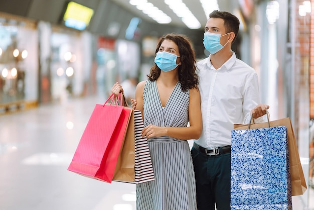 Beautiful young loving couple shopping together Black friday concept