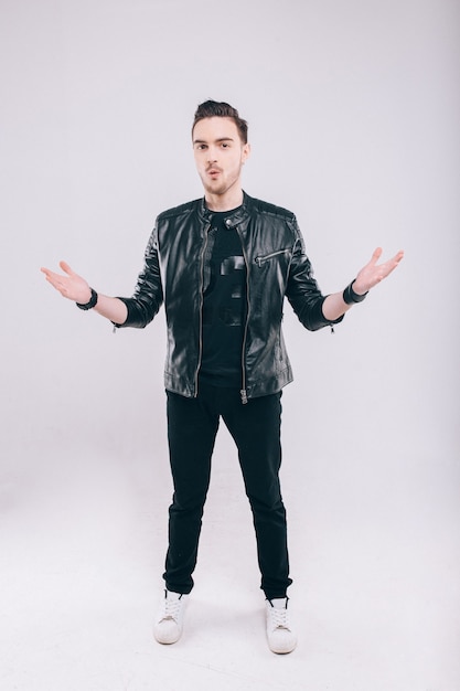 Beautiful young man in studio in jacket