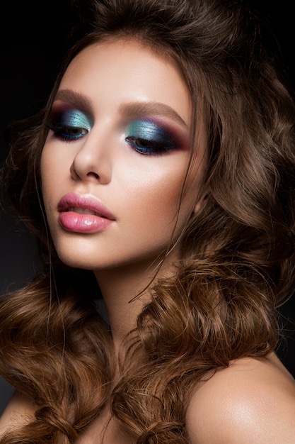 Beautiful young model with bright makeup and sunburn skin Evening make up