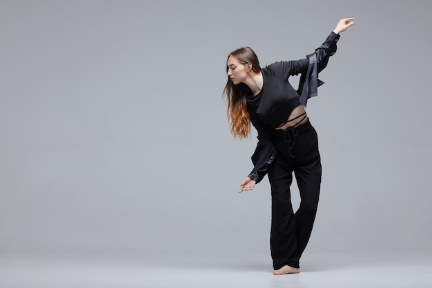 Beautiful young modern dancer or fitness dancer on a white isolated background