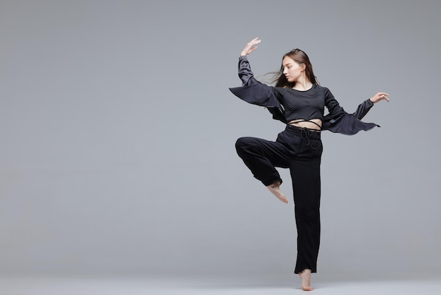 Beautiful young modern dancer or fitness dancer on a white isolated background