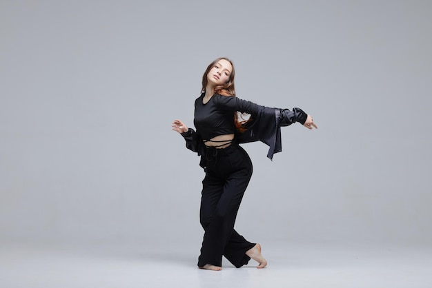 Beautiful young modern dancer or fitness dancer on a white isolated background