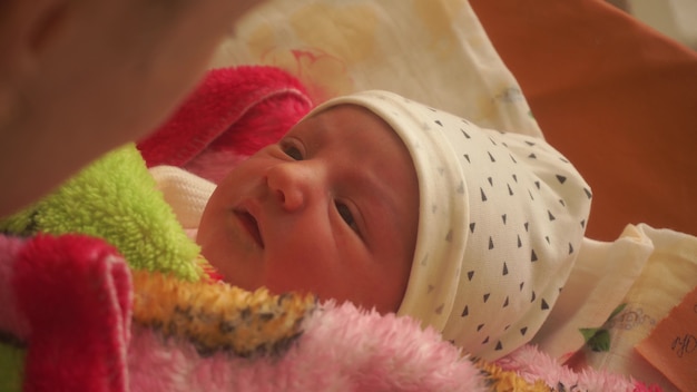 Beautiful young mom with newborn baby in her arms