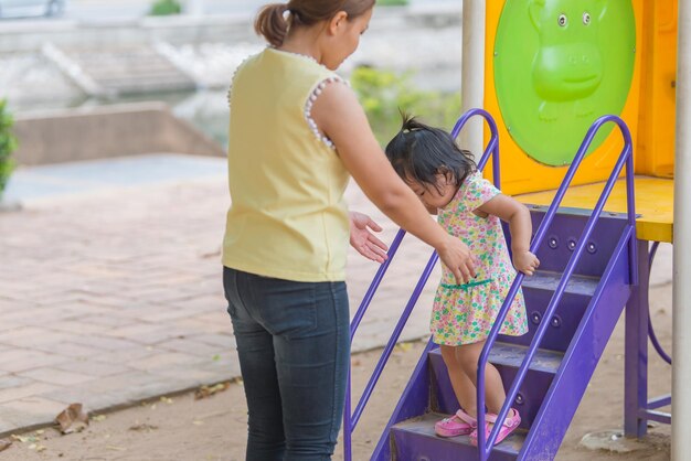 Beautiful young mother play with your daughter with fun at playgroundHappy mother dayThailand people