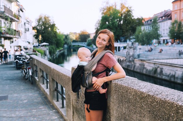 Beautiful young mother with baby child spend time in the old town of Ljubljana Slovenia Europe