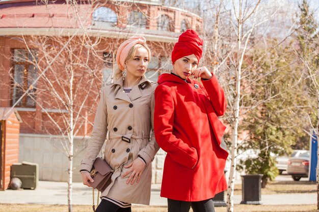 Beautiful young muslim women girlfriends on a walk in the city