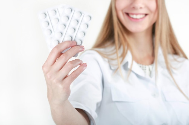 A beautiful young nurse offering pills