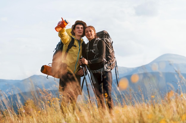 Beautiful young people travel together Majestic Carpathian Mountains Beautiful landscape of untouched nature