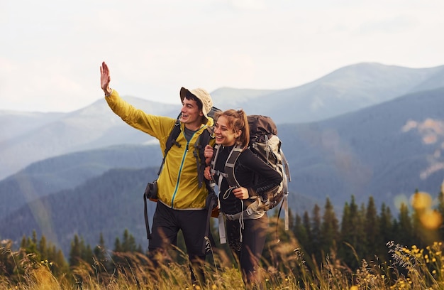 Beautiful young people travel together Majestic Carpathian Mountains Beautiful landscape of untouched nature