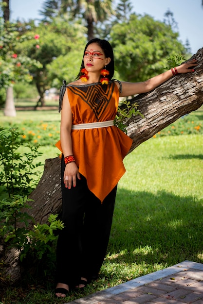 야네샤 문화의 아름다운 젊은 페루 여성은 드레스, 보석, 메이크업 옷으로 포즈를 취하고 있습니다.