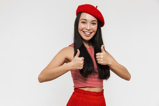 beautiful young pretty asian happy woman posing isolated over white wall make thumbs up gesture.