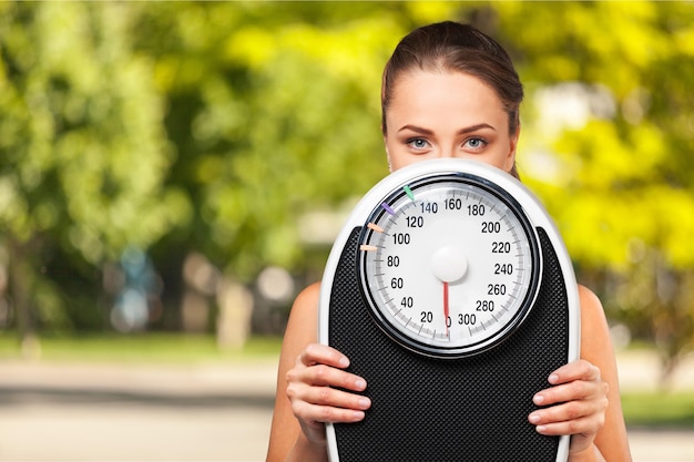 Photo beautiful young s woman holding scales