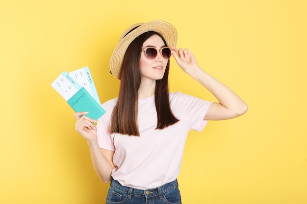 Beautiful young smiling girl holds tickets for travel rest travel tour