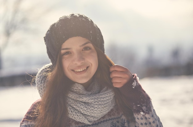 Beautiful young smiling woman outside in the winter