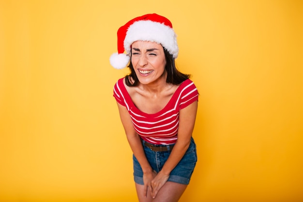 Beautiful young smiling woman in Santa hat isolated