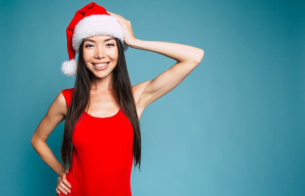 Beautiful young smiling woman in Santa hat isolated