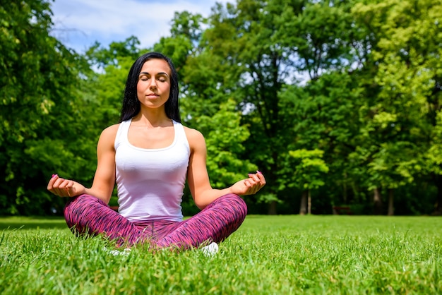 Beautiful young sporty girl in a park