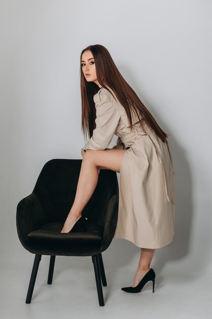 Beautiful Young Stylish woman in Coat. Studio shot
