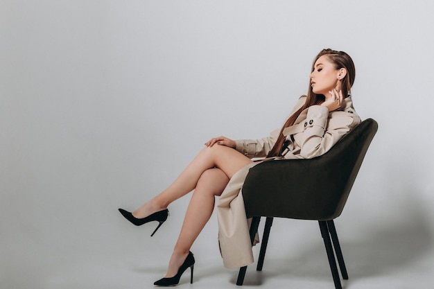 Beautiful Young Stylish woman in Coat. Studio shot