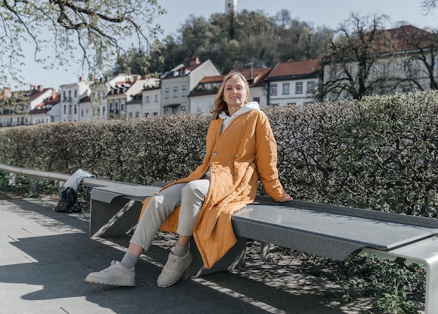 A beautiful young stylish woman walking in the city Spring mood lifestyle concept