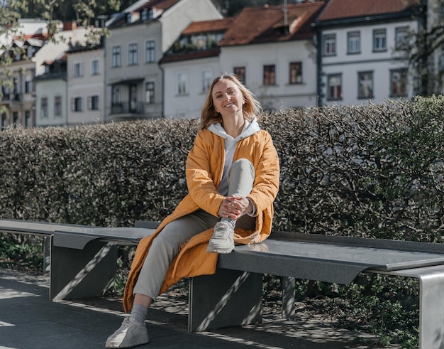 A beautiful young stylish woman walking in the city Spring mood lifestyle concept