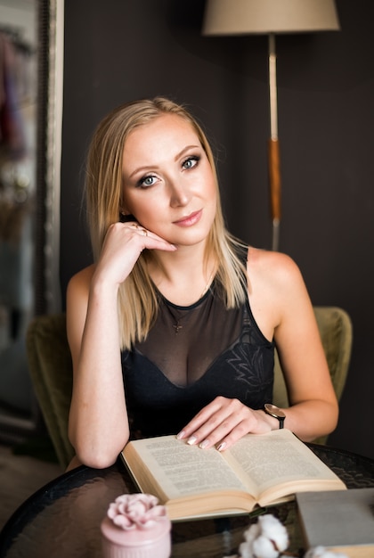 Beautiful young successful blonde woman reading a book 