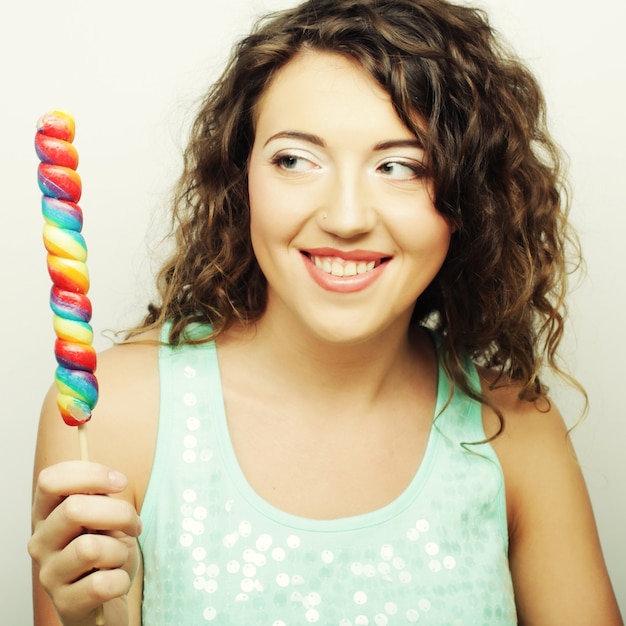 Beautiful young surprised curly woman. Studio shot.