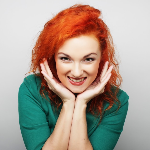 Beautiful young surprised woman. Studio shot.