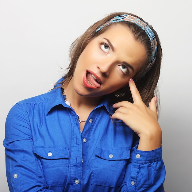 Beautiful young surprised woman. Studio shot.