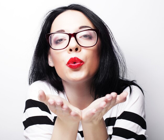 Beautiful young surprised woman. Studio shot.