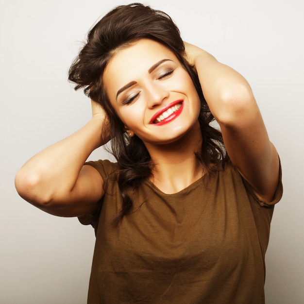 Beautiful young surprised woman. Studio shot.