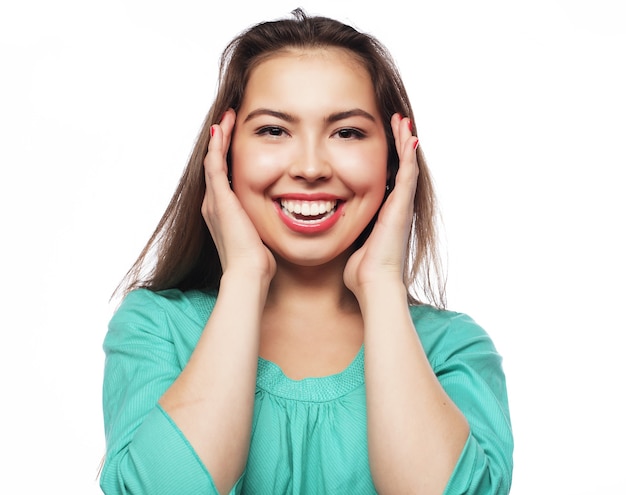 Beautiful young surprised woman on white