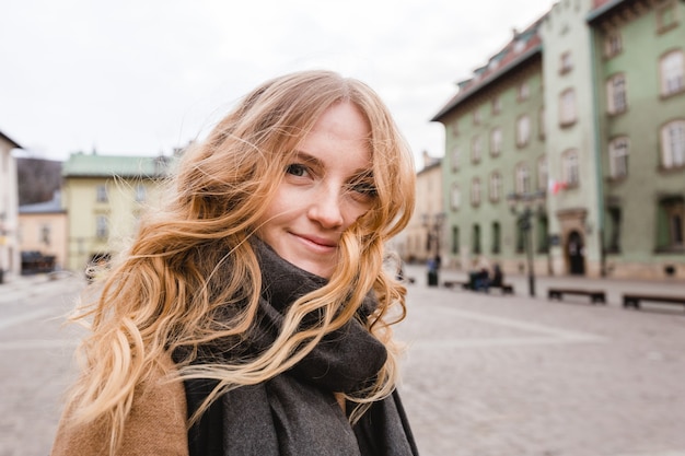 Beautiful young tourist woman walking on the street.